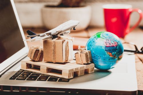 close-up-model-airplane-with-boxes-globe-laptop