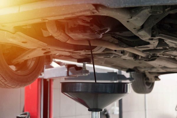 Draining-the-Oil-of-a-Car-in-an-Oil-Drain-Tank_11zon
