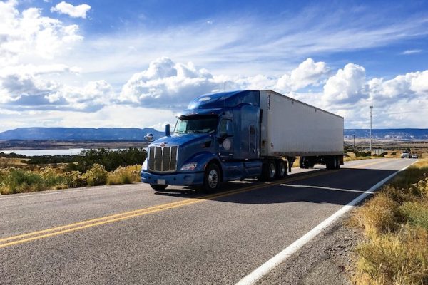 semi-truck-moving-highway-against-sky_1048944-10739449