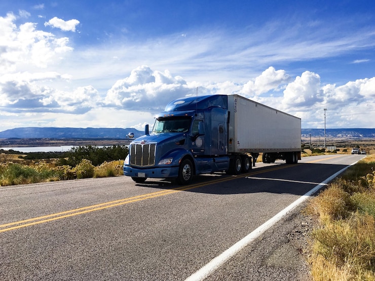 semi-truck-moving-highway-against-sky_1048944-10739449